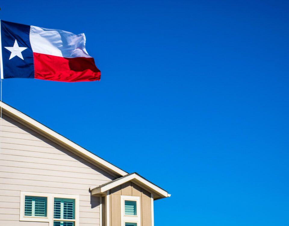 Texas State Flag the Symbol of the Lone Star State above Modern Brand New Suburban Home